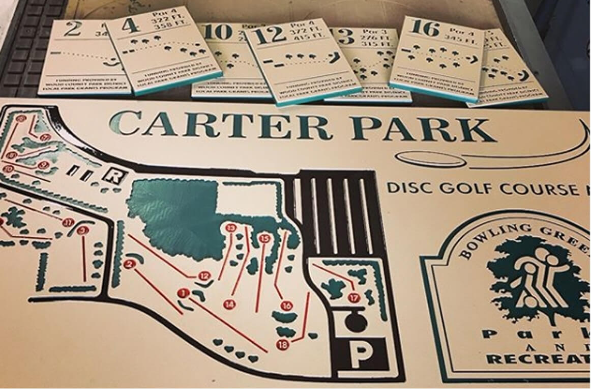 Carter Park disc golf course map sign with individual hole tee signs