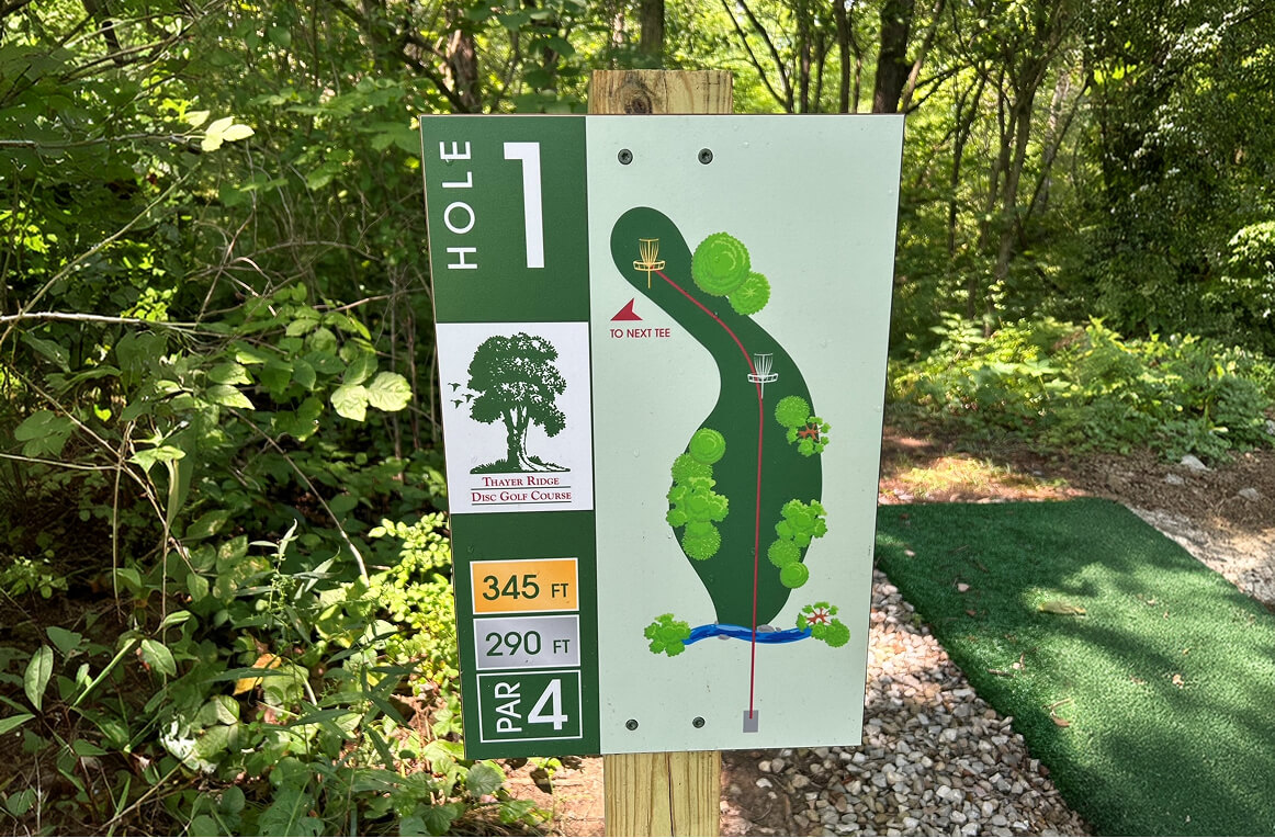 Hole 1 disc golf sign with course layout map and distance markers